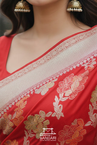 Red saree with floral patterns and gold jewelry