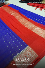 Red and blue Banarasi georgette saree with intricate patterns on a plain background