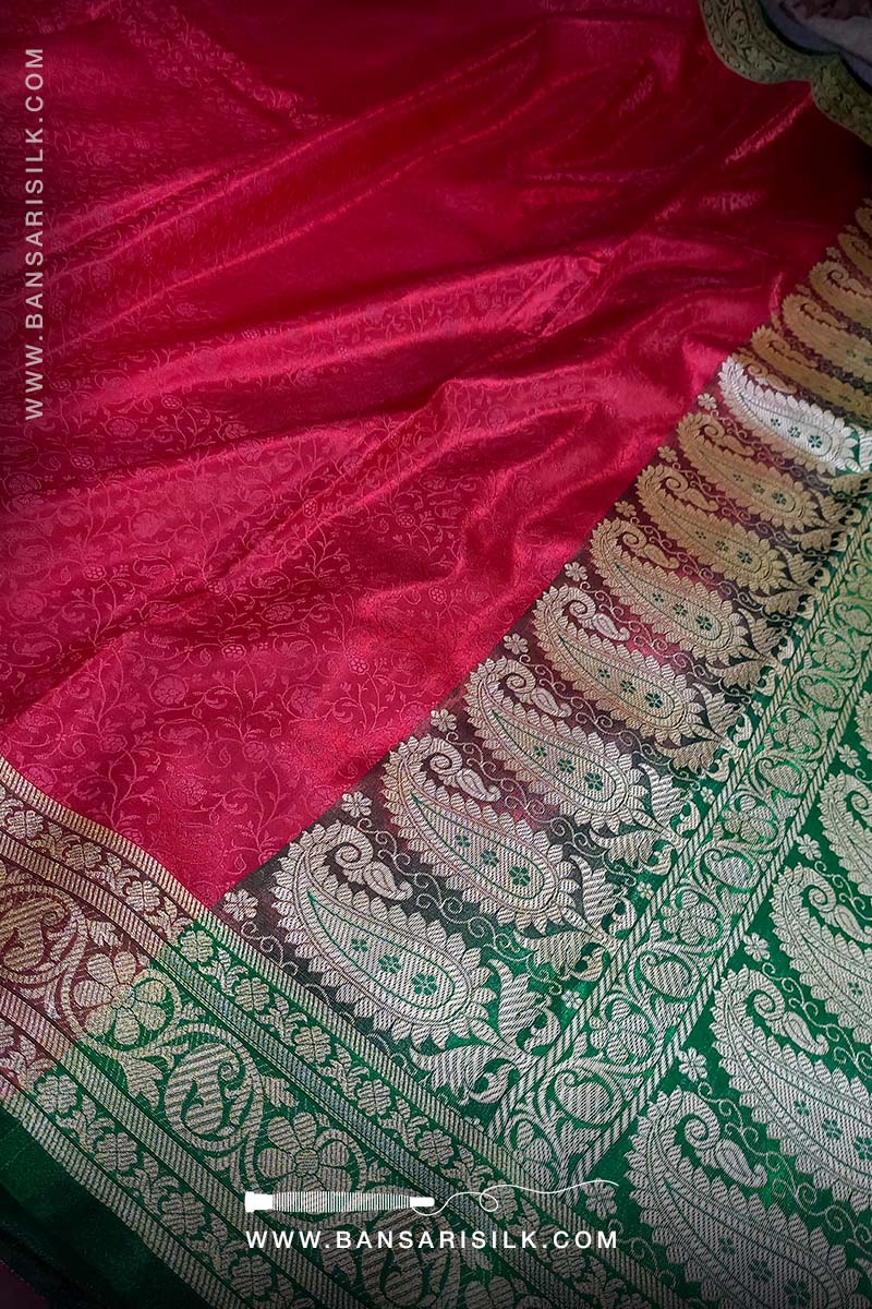 It is a red and green Banarasi Silk Saree woven in Tanchoi design, best for Indian weddings by bansarisilk.com