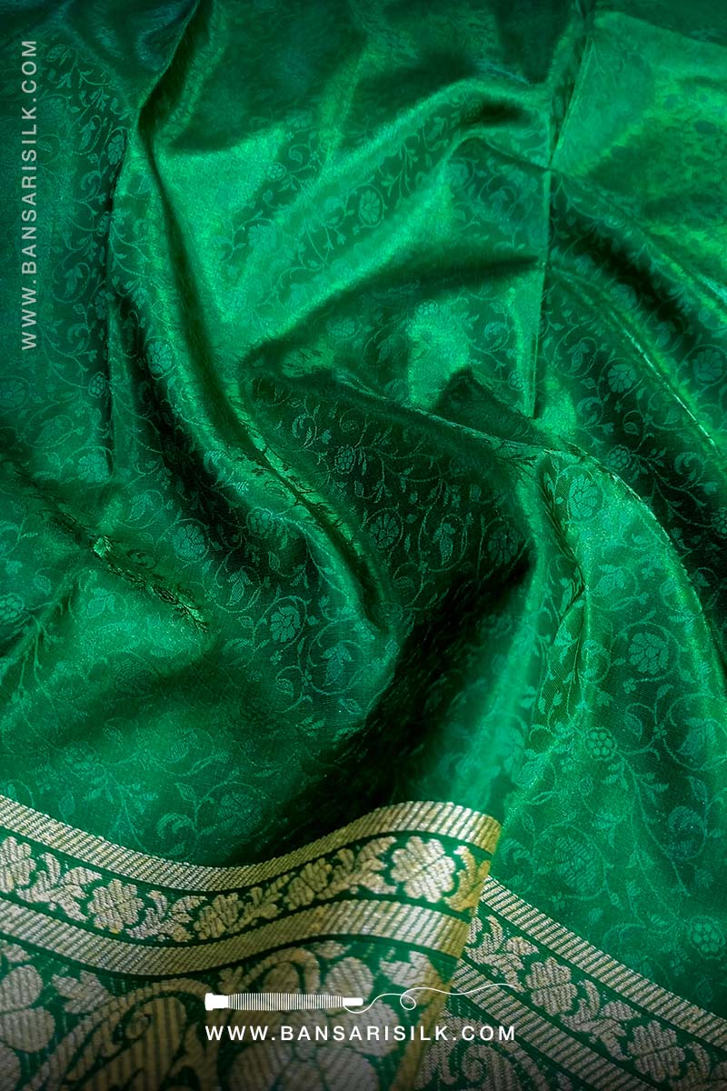 It is a red and green Banarasi Silk Saree woven in Tanchoi design, best for Indian weddings by bansarisilk.com