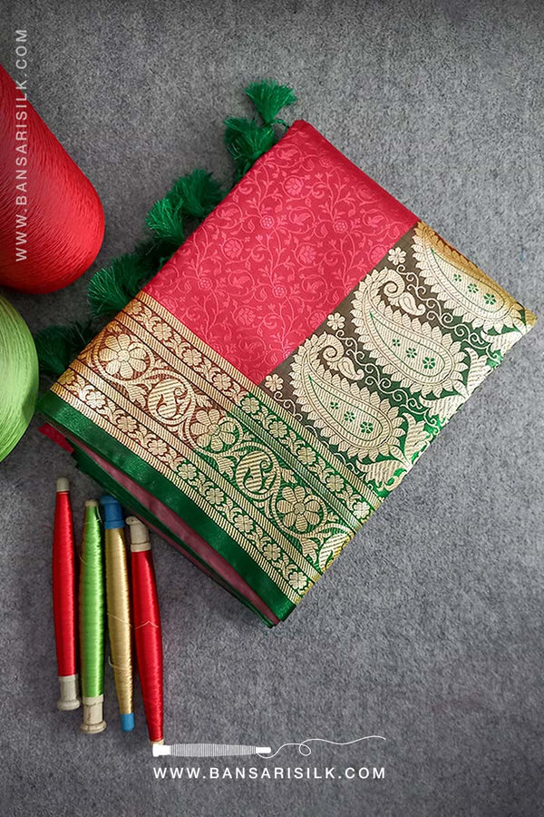 It is a red and green Banarasi Silk Saree woven in Tanchoi design, best for Indian weddings by bansarisilk.com