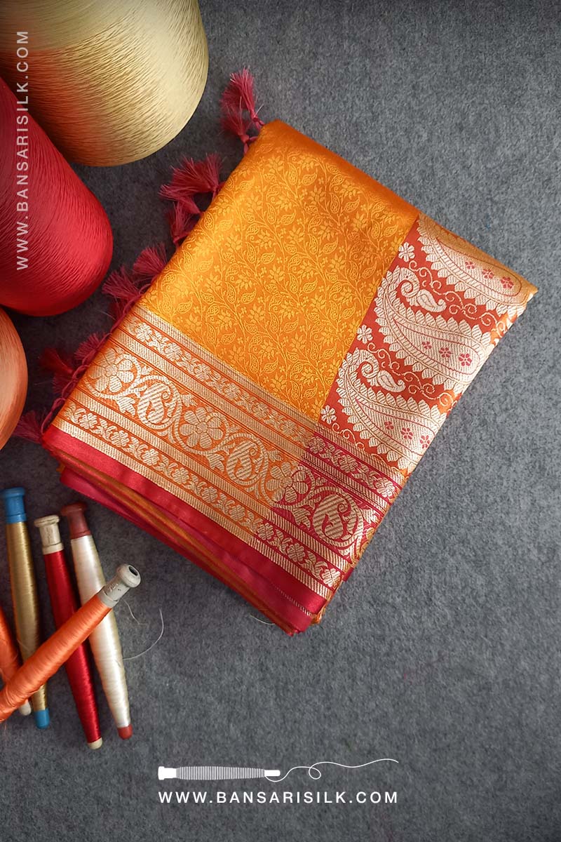 It is a yellow and red Banarasi Silk Saree woven in Tanchoi design, best for haldi and Indian weddings by bansarisilk.com